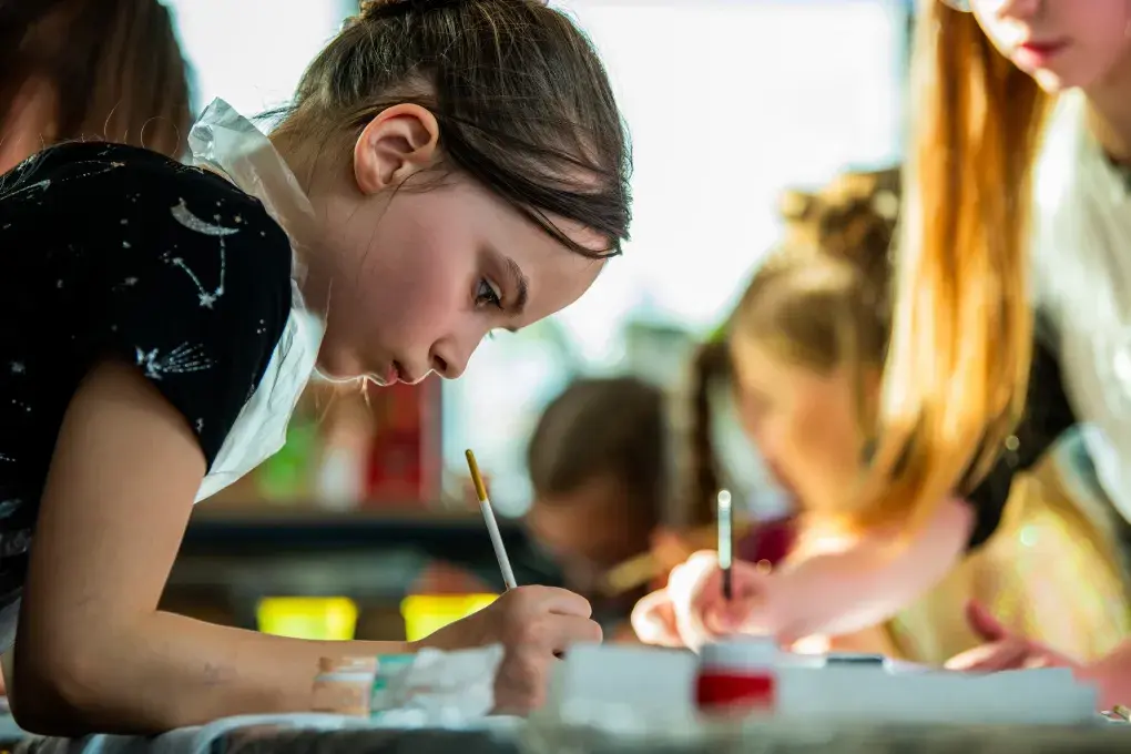 Une jeune fille fait de la peinture.