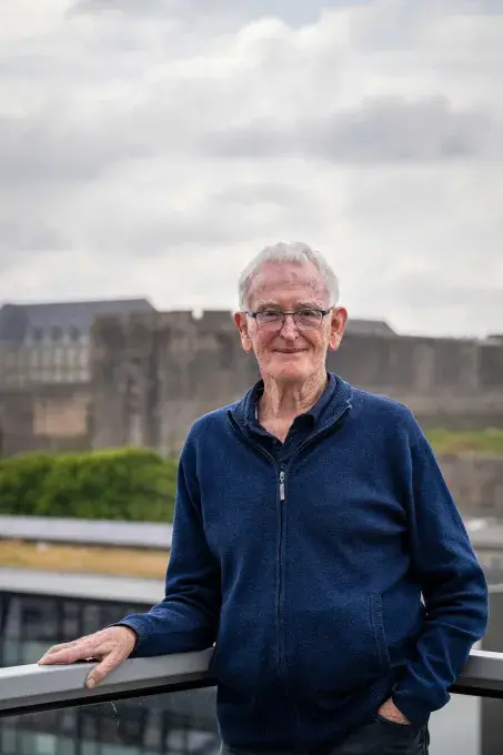 Un homme posant devant le château de Brest