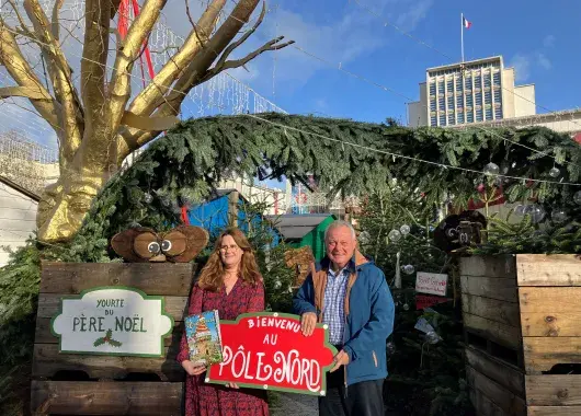 Un homme et une femme sur le marché de Noël de Brest, en cours d'installation. 