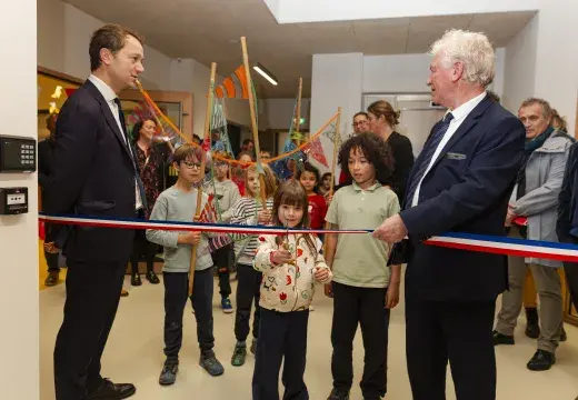 Deux adultes entourent des enfants.