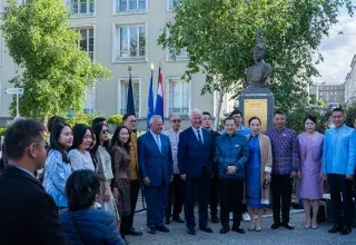 Plusieurs personnes devant une statue.