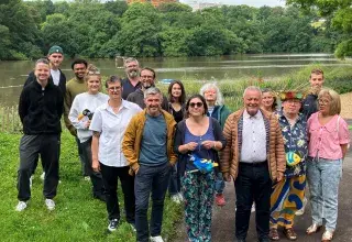 Un groupe d'hommes et de femmes posent sur les rives de Penfeld.  